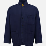 The ORIGINAL MADRAS Herringbone Twill Soft Jacket is crafted from navy cotton with a subtle herringbone pattern. It features a classic button-up design, a stand collar, and three front pockets, and is displayed on a plain white background.