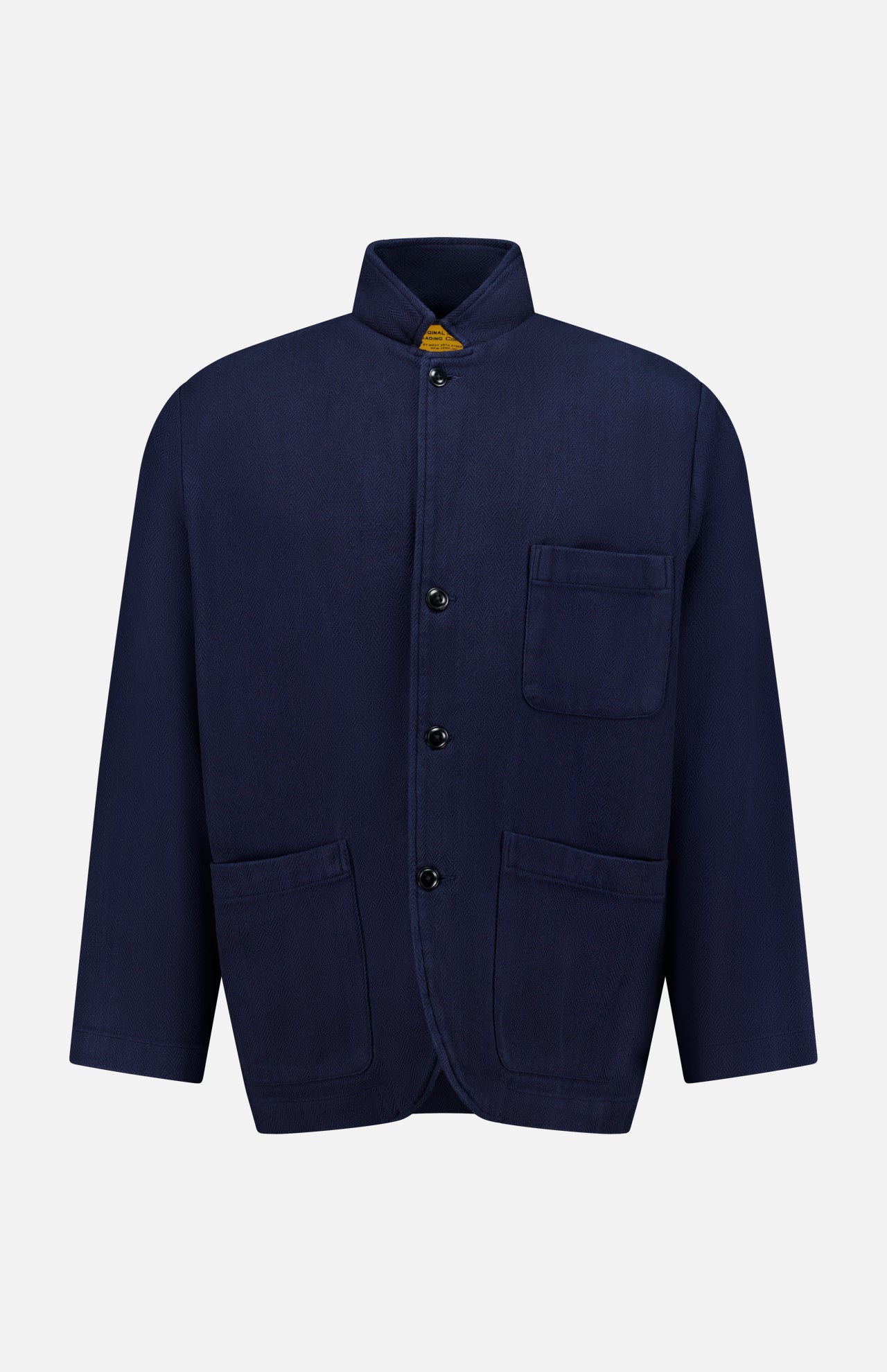 The ORIGINAL MADRAS Herringbone Twill Soft Jacket is crafted from navy cotton with a subtle herringbone pattern. It features a classic button-up design, a stand collar, and three front pockets, and is displayed on a plain white background.