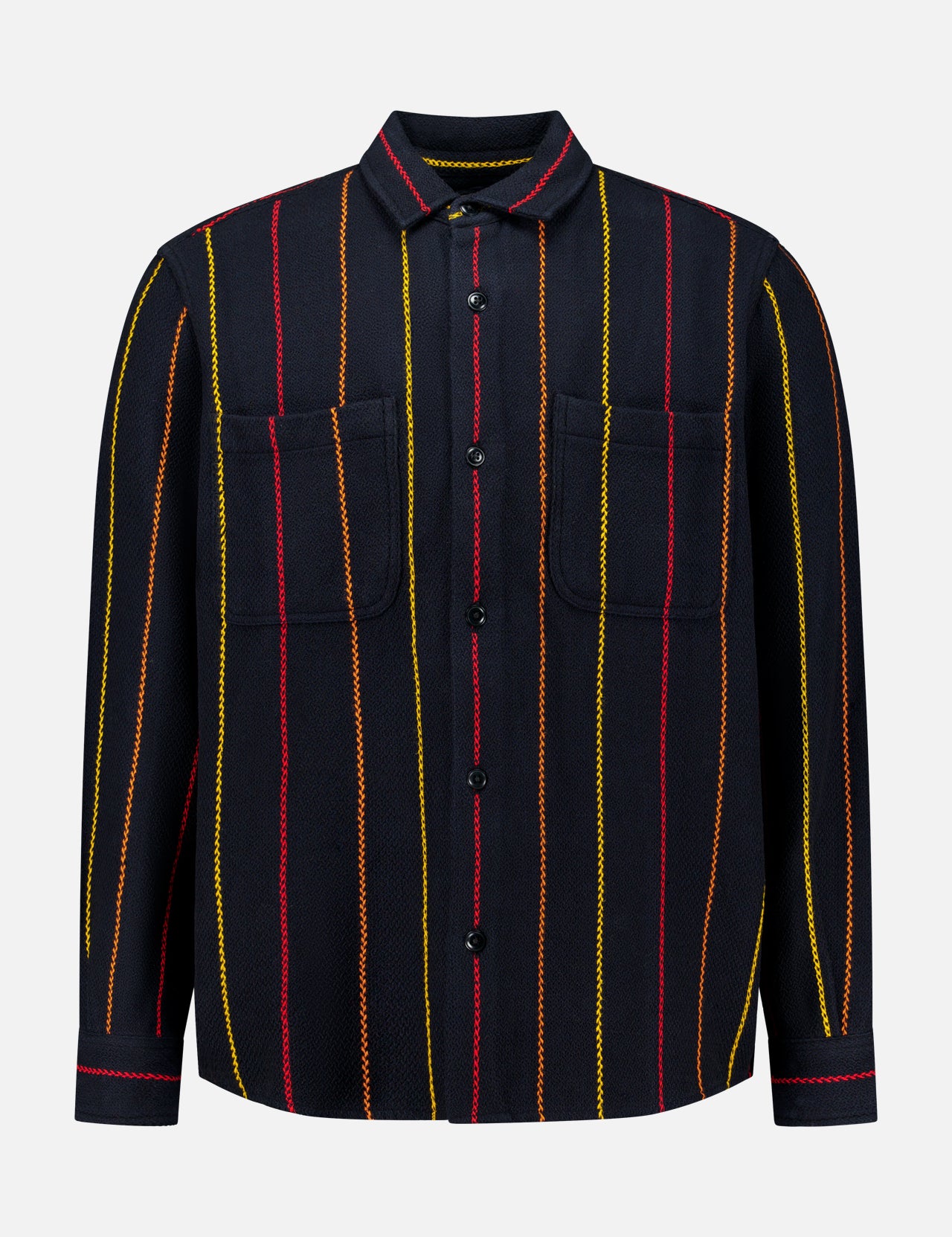The Pinstripe Roundtail Overshirt by ORIGINAL MADRAS is a long-sleeve, button-up black overshirt made from premium Indian cotton, designed with vertical yellow, red, and orange pinstripes and finished with two chest pockets. It is displayed against a plain white background.