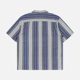 The ORIGINAL MADRAS Stripe Lax Camp Shirt is a short-sleeve, blue and grey button-up made from pure Indian cotton with vertical stripes, shown laid flat from the back on a plain light background.