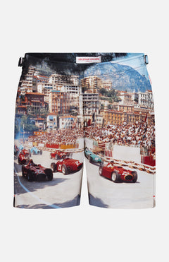 ORLEBAR BROWN Bulldog Photographic Race Car Shorts feature a vivid Grand Prix de Monaco print with classic race cars speeding past grandstands, city buildings, and mountains in the background.