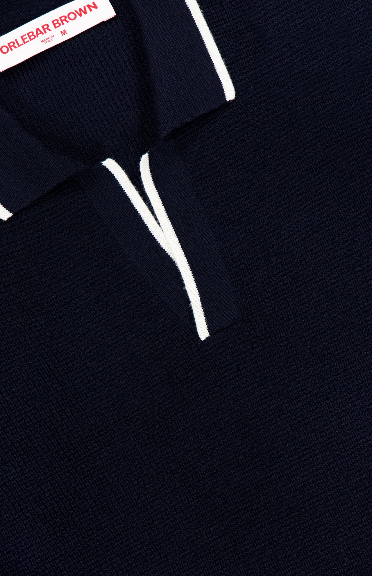 Close-up of the ORLEBAR BROWN Horton Stripe Johnny Collar Polo, featuring a Johnny collar with white trim along the collar and opening. A visible ORLEBAR BROWN label appears at the top.