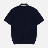 The ORLEBAR BROWN Horton Stripe Johnny Collar Polo in navy wool is displayed from the back on a light grey background, highlighting its ribbed hem and Johnny collar with a thin white trim.