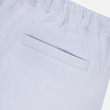 Close-up of ORLEBAR BROWN’s Alex Relaxed Linen Pants in light blue, featuring a relaxed fit, elastic waistband, and a single welt back pocket.