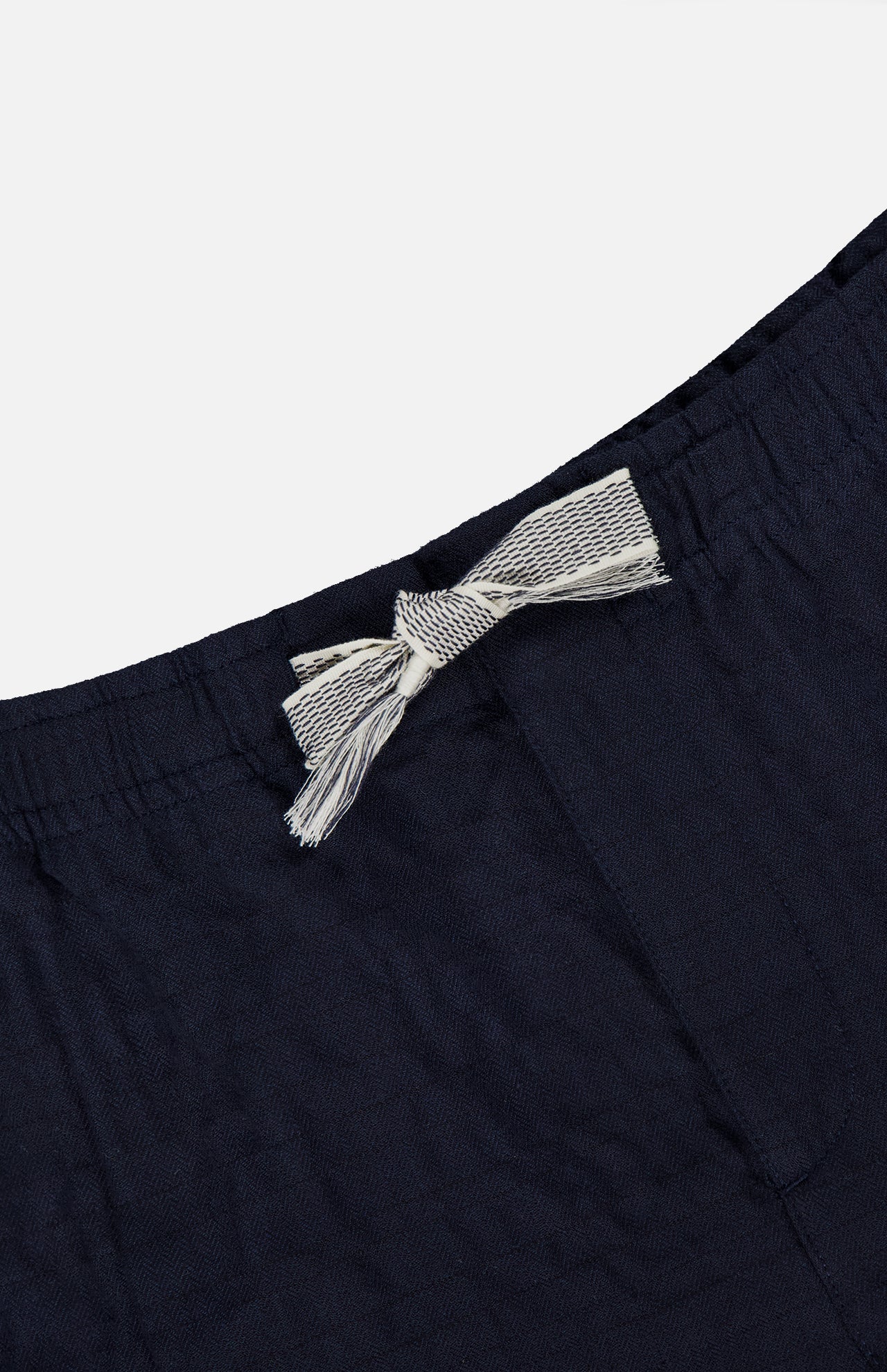 Close-up of the Alex Sereno Cotton Shorts by ORLEBAR BROWN, featuring a navy waistband with a white and gray striped drawstring tied in a bow against a plain light background.