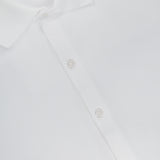 Close-up of the ORLEBAR BROWN Bruno 3 Button Pique Polo Shirt in classic fit white cotton pique, showcasing three white buttons on the placket and a partially visible red and white label at the neckline.