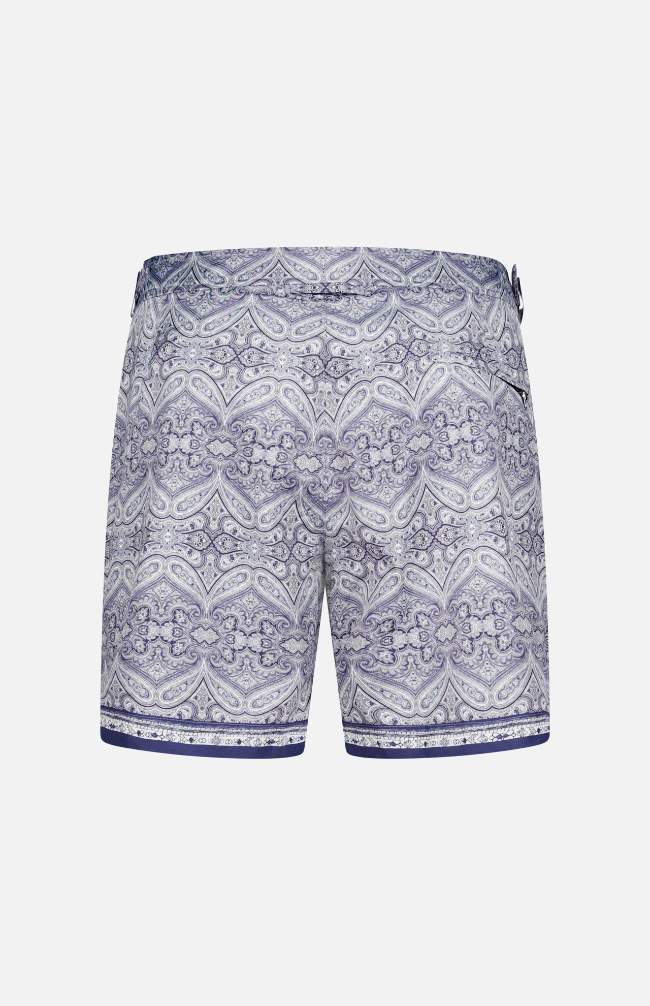 The ORLEBAR BROWN Bulldog Carnival Swim Trunk features a detailed blue and white paisley print, adjustable side buckles, and a dark blue hem stripe, shown against a plain white background.