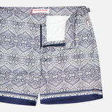 The ORLEBAR BROWN Bulldog Carnival Swim Trunk features a blue and white paisley print, front snap and zip closure, inner white mesh lining, and adjustable side buckles for a perfect fit.