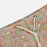 Close-up of ORLEBAR BROWN Bulldog Drawcord Carnival Paisley Swim Shorts: vibrant paisley print swim trunks with a white drawstring, featuring bold green, pink, and orange swirls on a crisp white background.