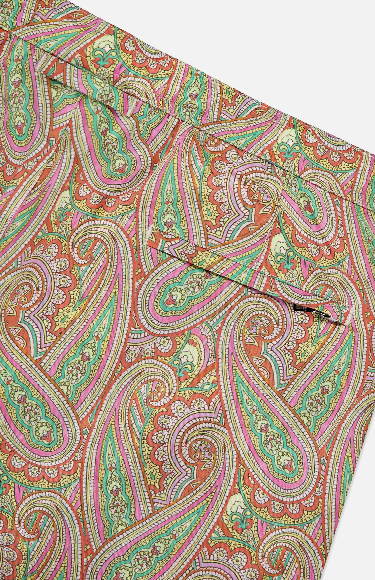Close-up of ORLEBAR BROWN's Bulldog Drawcord Carnival Paisley Swim Shorts, featuring colorful green, pink, yellow, and red paisley print with visible seams and part of a pocket.
