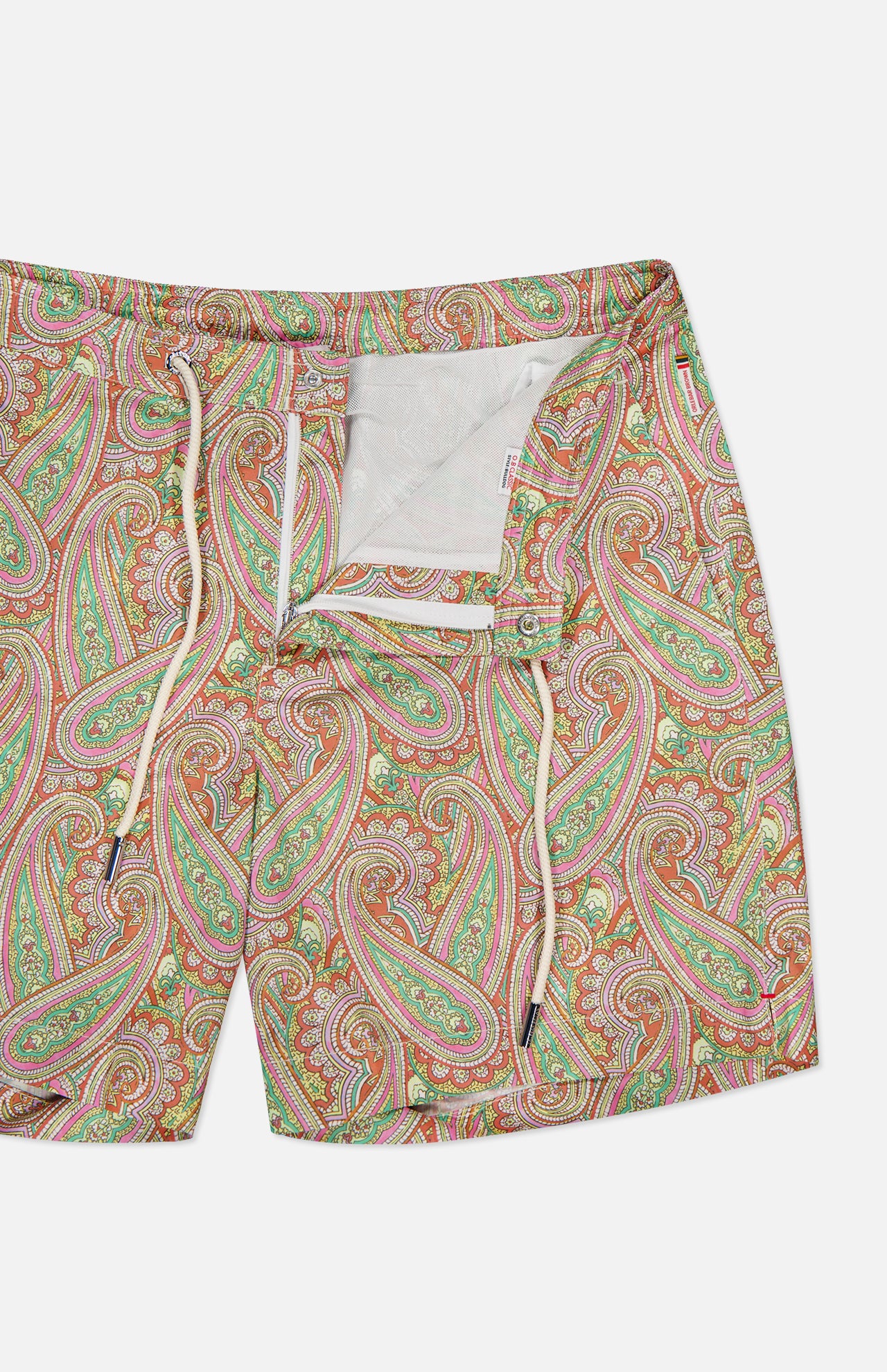 ORLEBAR BROWN Bulldog Drawcord Carnival Paisley Swim Shorts for men feature a vibrant red, green, and orange paisley print, cream drawstring, partially open fly with white mesh lining, shown on a plain white background.