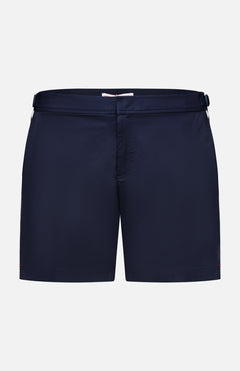 ORLEBAR BROWN Bulldog Stretch Shorts: navy men's swim trunks with a flat front, waistband, and adjustable side tabs, featuring a classic, unbranded style and no patterns. Shown on a plain white background.