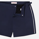 ORLEBAR BROWN Bulldog Stretch Shorts in navy, featuring a side buckle, adjustable side tabs, button closure, and white vertical stripe detail. The inner waistband displays the brand name.