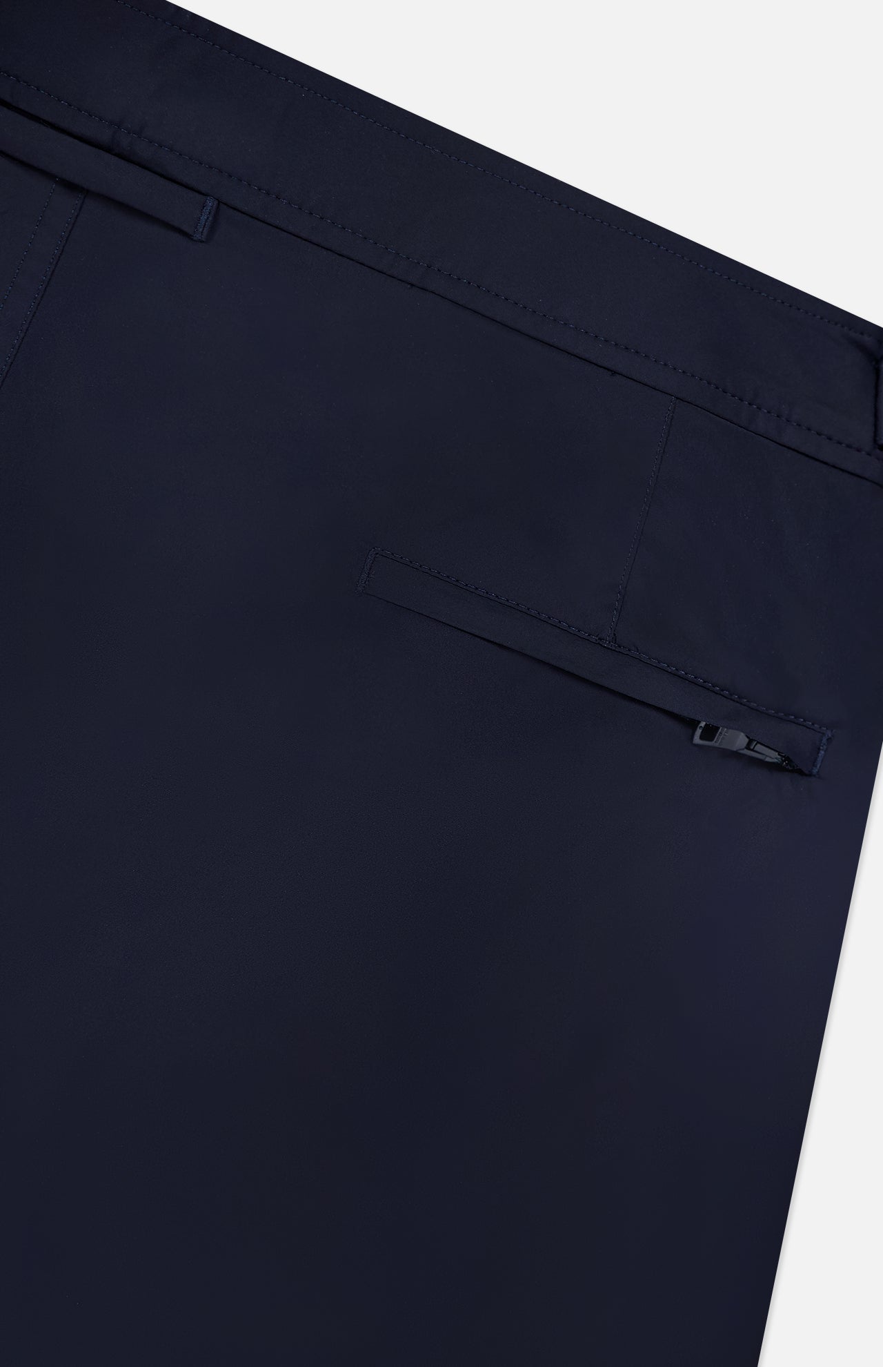 Close-up of ORLEBAR BROWN Bulldog Stretch Shorts in navy, showcasing a single welt button pocket, clean stitching, and adjustable side tabs for a tailored fit.