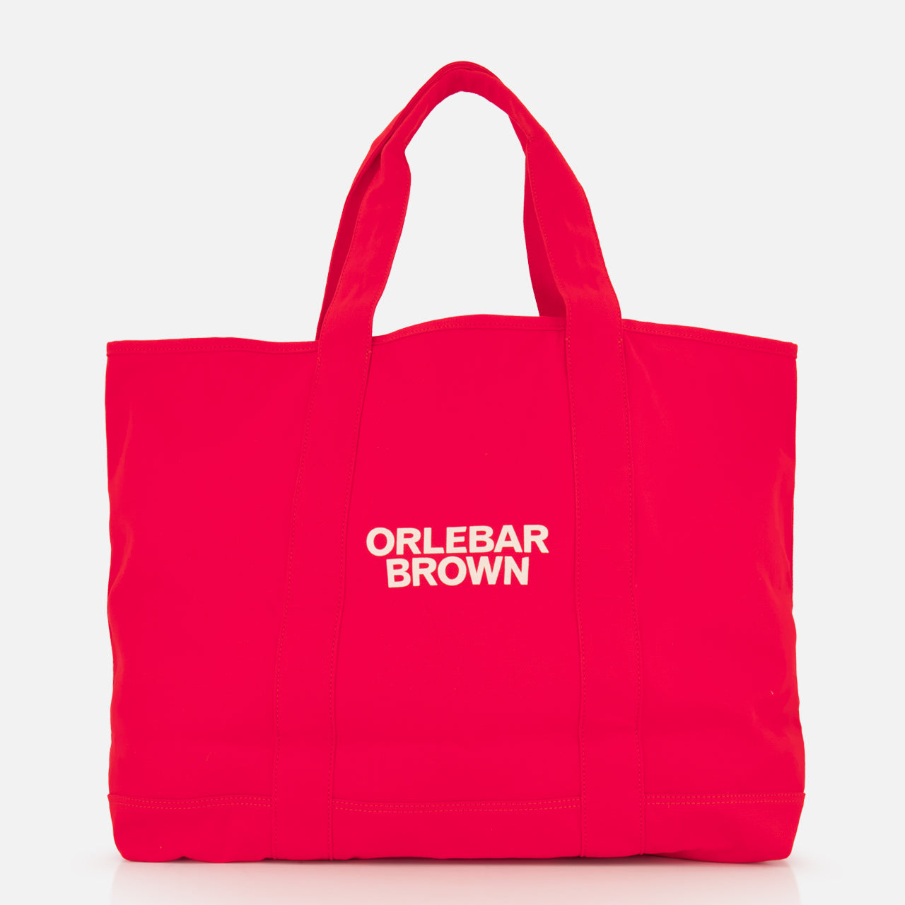 The Beach Bound Bag by ORLEBAR BROWN is a bright red organic cotton canvas tote with two handles and a white centered logo, shown on a plain white background.