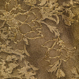 Close-up of the PAMELLA ROLAND Jacquard Cocktail Dress, showcasing intricate floral brocade with raised, shimmering textures that radiate gilded glamour.