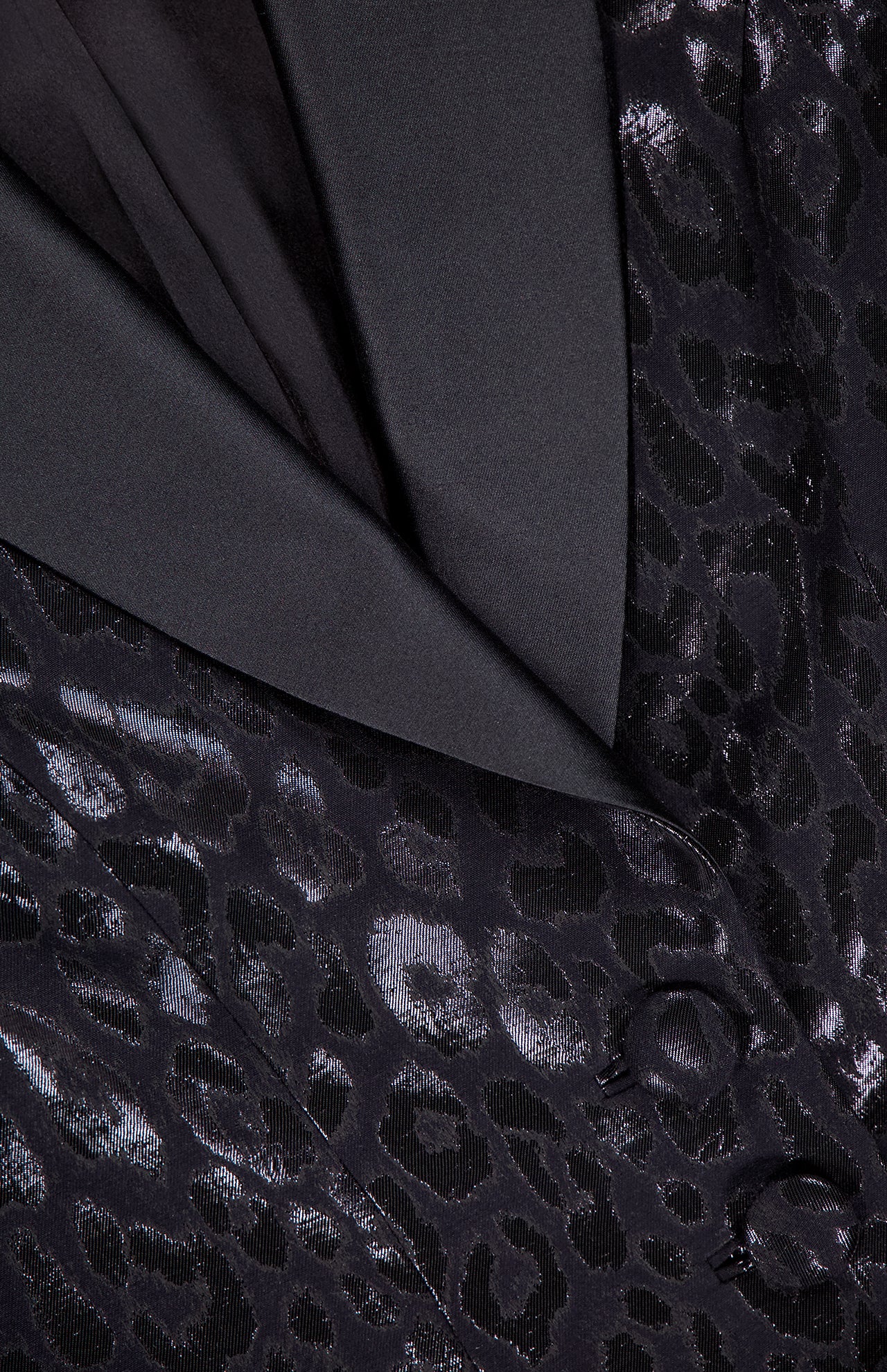 Close-up of the PAMELLA ROLAND Lurex Jacquard Leopard Print Jacket featuring a shiny, subtle leopard pattern, fabric-covered buttons, and a smooth black lapel.