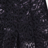 Close-up of PAMELLA ROLAND’s Lurex Jacquard Leopard Print Pant in black, featuring a shiny metallic leopard pattern. The glossy fabric catches the light, and the waistband with side zipper is partially visible.