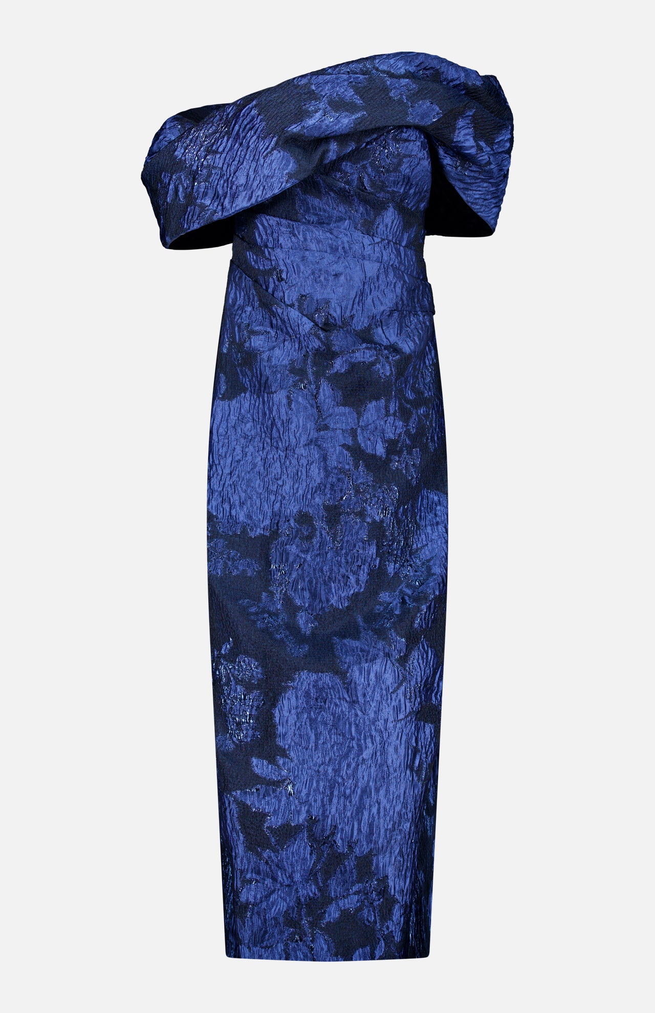 PAMELLA ROLAND’s Fil Coupe Off The Shoulder Gown features a fitted, off-the-shoulder silhouette with an asymmetrical neckline and textured crinkled floral fil coupé pattern on a light gray background.