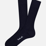 A pair of Laburnum Short 5x3 Rib Socks by PANTHERELLA in dark navy blue are laid flat on a white background, one slightly overlapping the other, with "PANTHERELLA" embroidered in white near the toe.