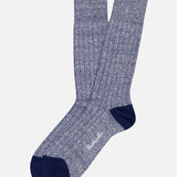 A pair of Hamada Sock by PANTHERELLA in heathered blue, featuring ribbed crew design and dark navy heels and toes. The socks overlap, with “Pantherella” printed in white near the toes.