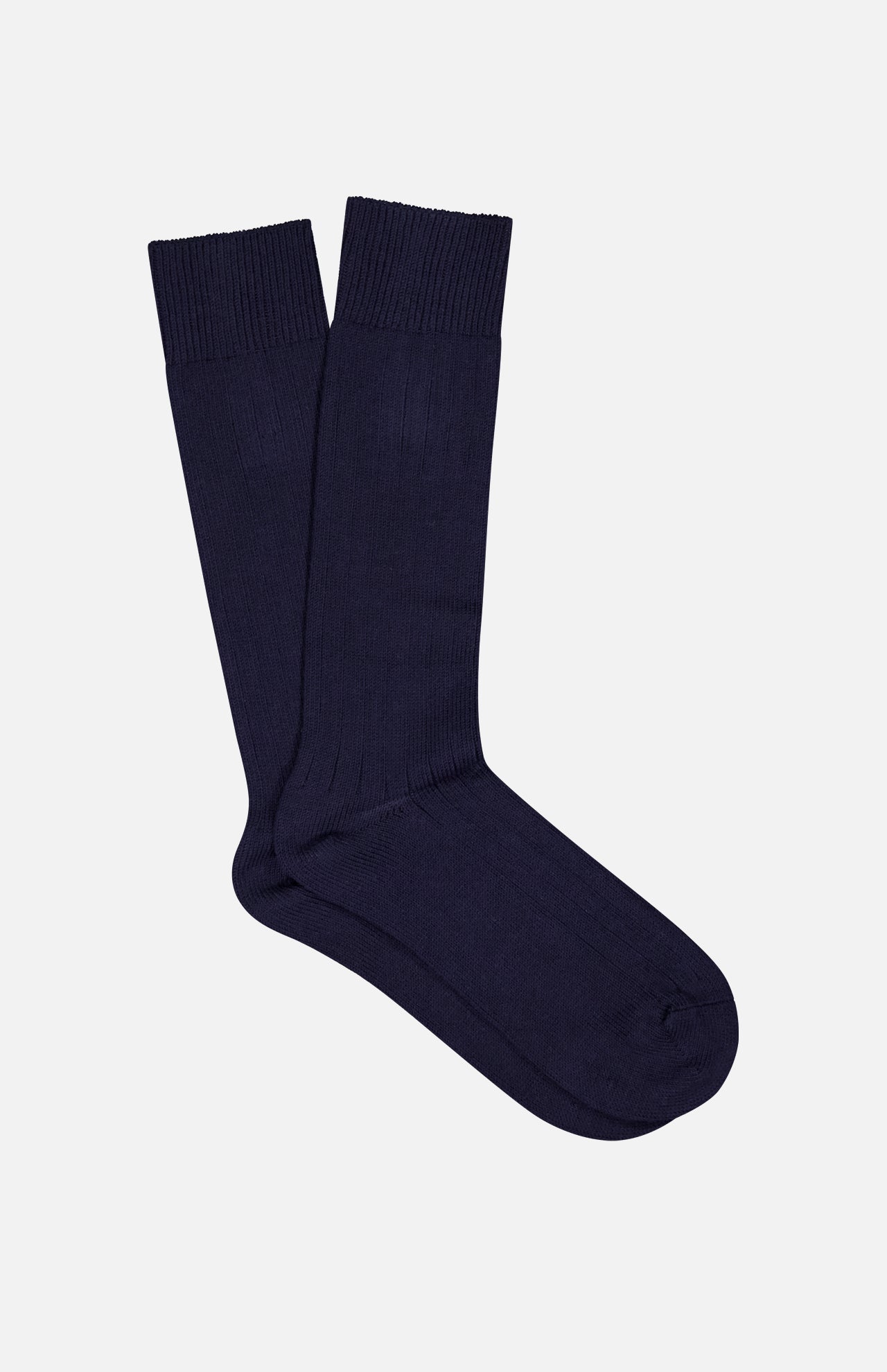 The Seaford Sock by PANTHERELLA is a pair of plain, dark navy blue crew socks made in England, shown laid flat on a light background.