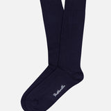 A pair of Seaford Socks by PANTHERELLA in navy blue ribbed organic cotton, featuring white brand embroidery near the toe—authentic English socks showcased on a plain white background.
