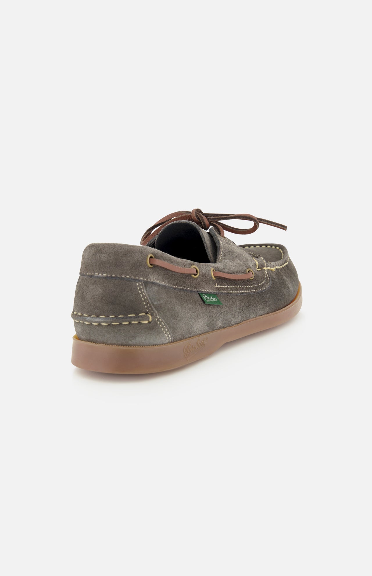 The Paraboot Barth Bateaux Boat Loafer is shown in grey suede with a tan rubber sole, brown leather laces, and visible stitching—highlighting classic hand-stitched craftsmanship from a back and side angle.