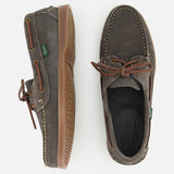 The Paraboot Barth Bateaux Boat Loafer is shown in brown suede with Norwegian welt construction and leather laces; one shoe is upright, the other on its side revealing the textured tan rubber sole.