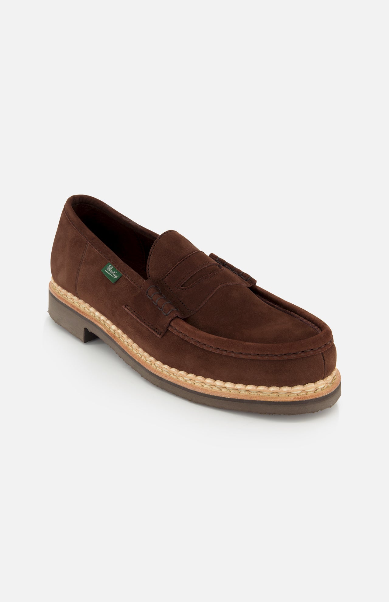 The Paraboot Nantes Slip On Loafer is a brown suede shoe with a low heel, visible stitching, Norwegian welt construction, a decorative upper strap, and a light tan welt, shown against a plain white background.