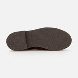 The image shows the bottom view of a dark brown textured sole from the Nantes Slip On Loafer by Paraboot, photographed on a plain white background. Made in France, this rugged sole provides excellent grip and durability.