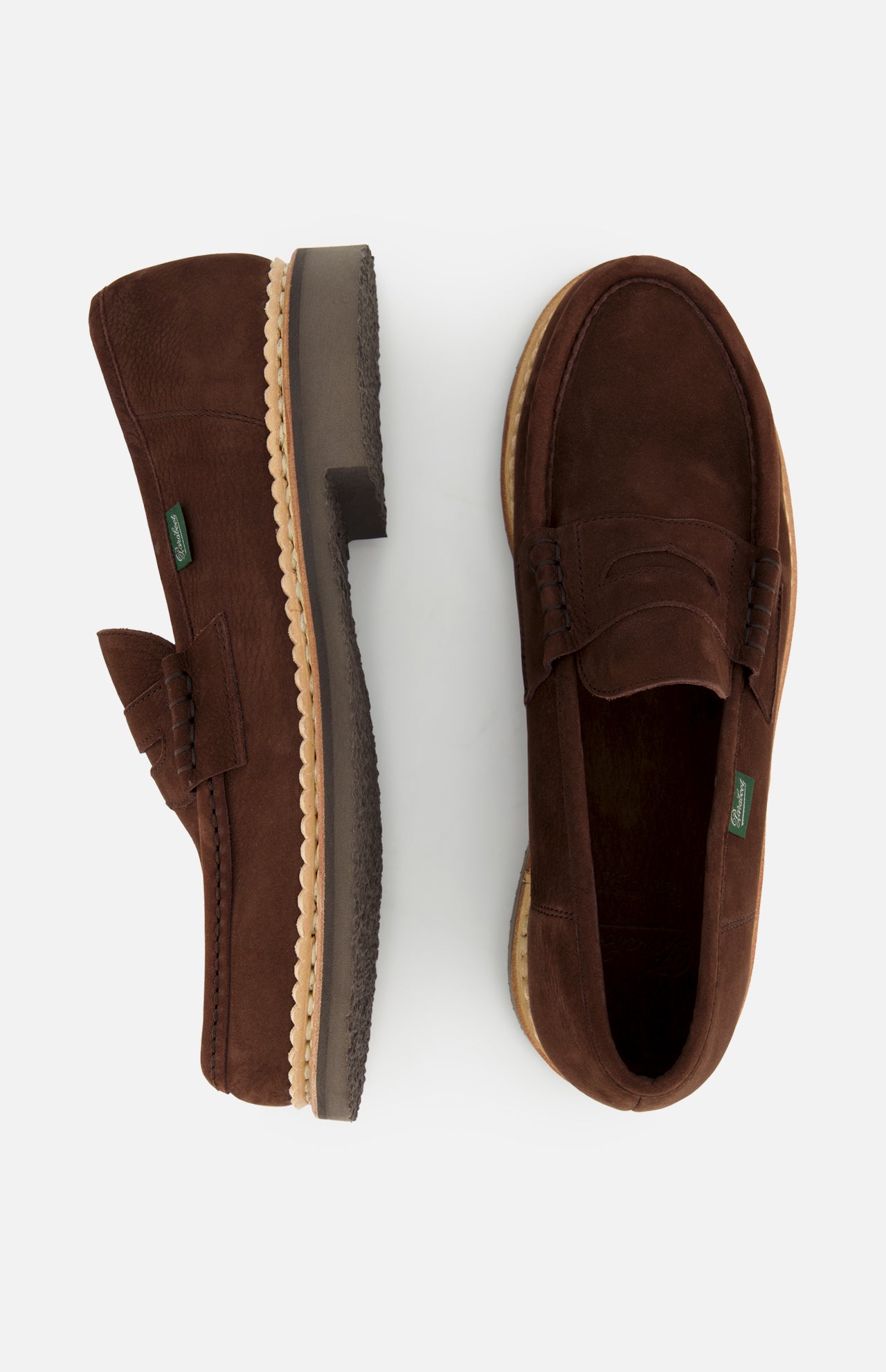 The Paraboot Nantes Slip On Loafer, in brown leather with tan rubber soles and Norwegian welt construction, is shown on a white background—one loafer from the side, the other from above.