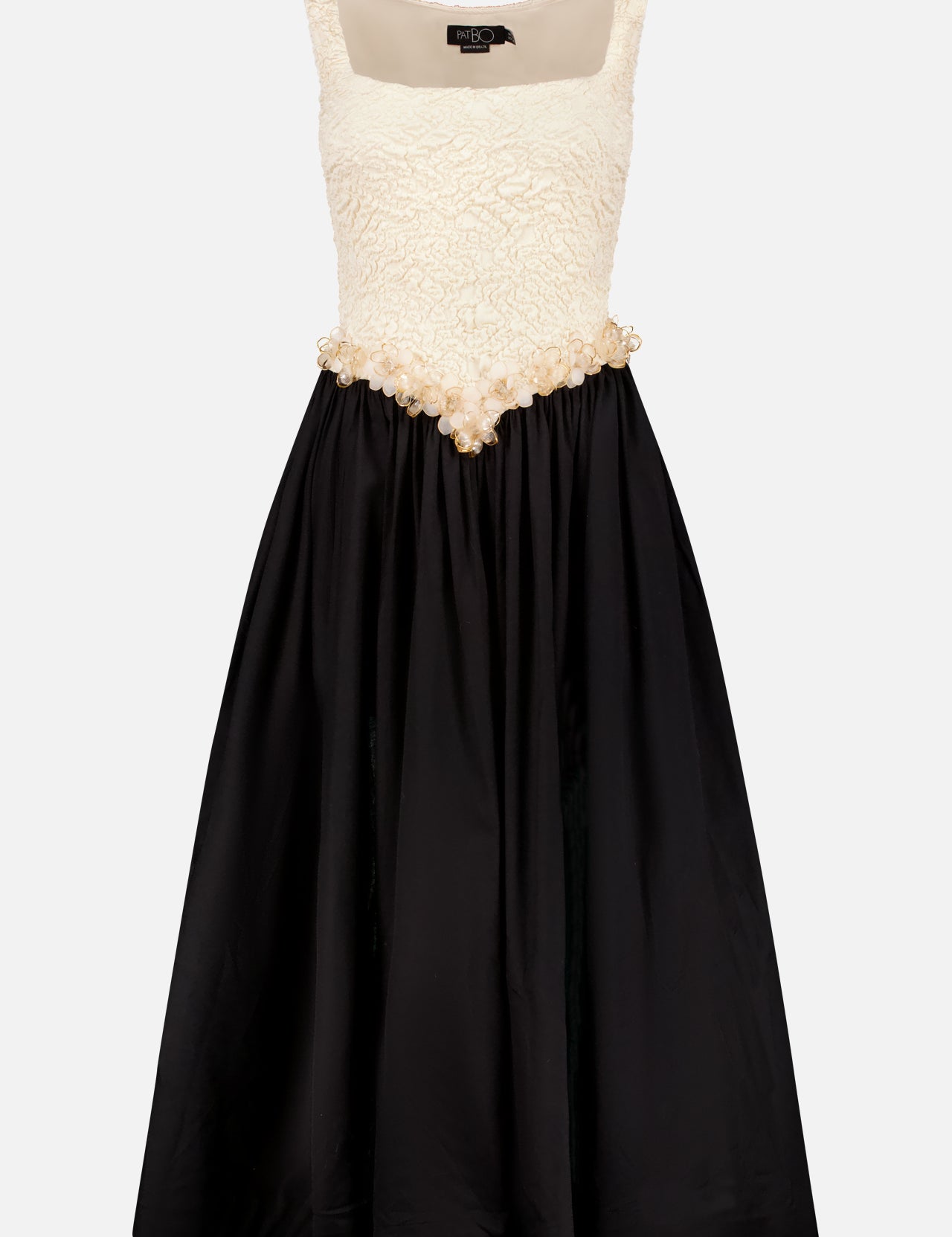 The Papillon Jacquard Midi Dress by PATBO features a sleeveless textured white bodice with embroidered flowers, a fitted waist with pearl accents, and a flared black satin skirt for classic elegance.