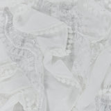 PATBO Bianca Lace Top in off-white featuring ruffled trim and pom-pom detailing.