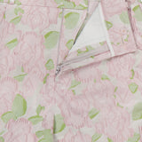 Close-up of PATBO’s Garden Jacquard Pants, featuring a pastel pale pink and green pattern, a partially open zipper, and a decorative button at the waistband—perfect for achieving a feminine, garden party aesthetic.