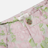 Close-up of PATBO’s Garden Jacquard Pants in pastel pink and green, featuring a jeweled button and signature brand label at the waistband—feminine trousers perfect for a garden party aesthetic.