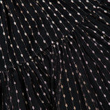 Close-up of the Olga Tulle Short Dress by PATBO showcases black sheer tulle adorned with diagonal rows of small, evenly spaced white dots, creating a textured and layered effect—an elegant detail ideal for enhancing a halter neckline party dress or mini dress.