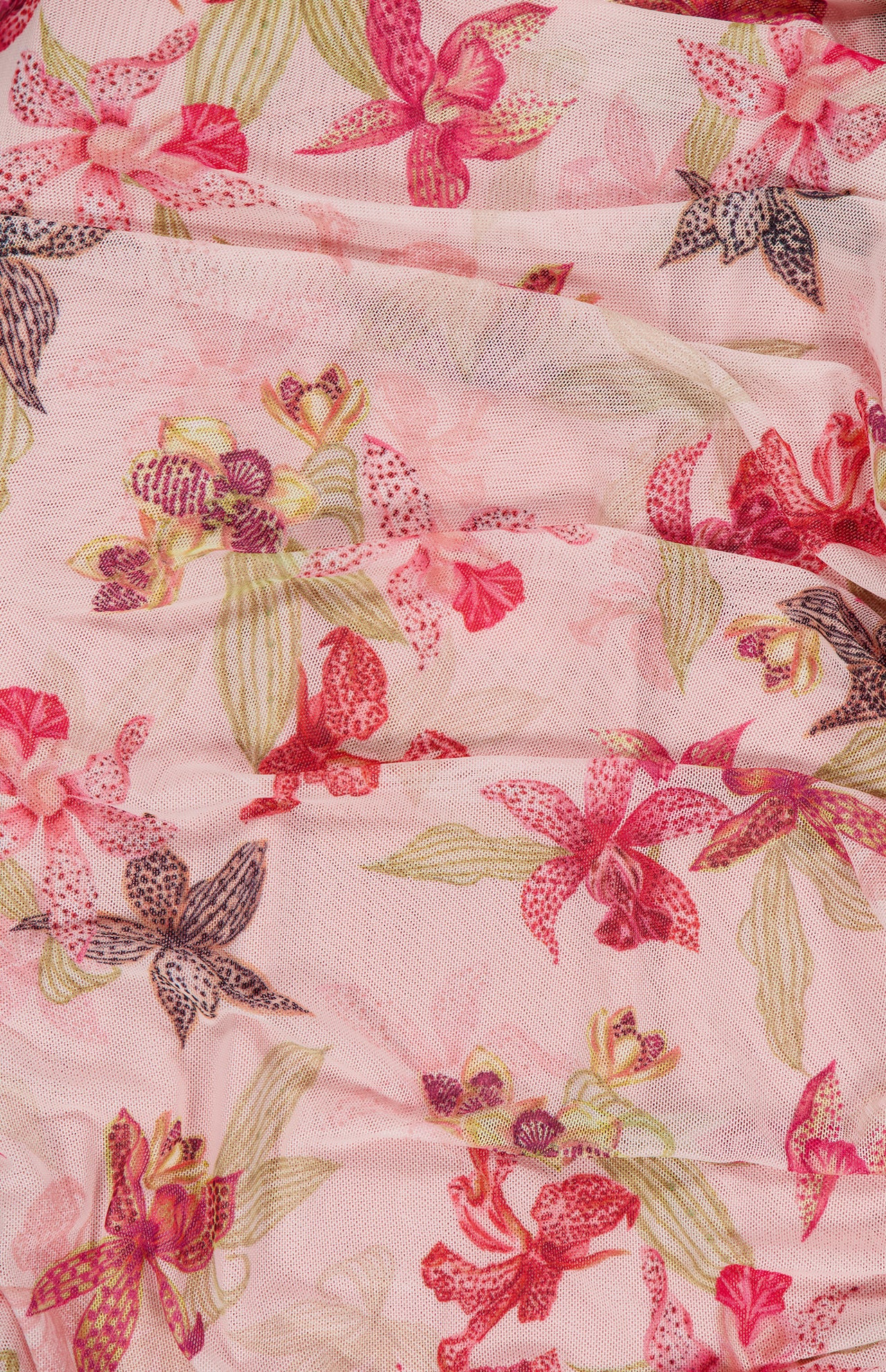 The PATBO Orchid Bloom One Shoulder Chiffon Mini Dress features sheer pink fabric with an orchid floral print in red, pink, purple, and green, softly gathered for a delicate, feminine look.