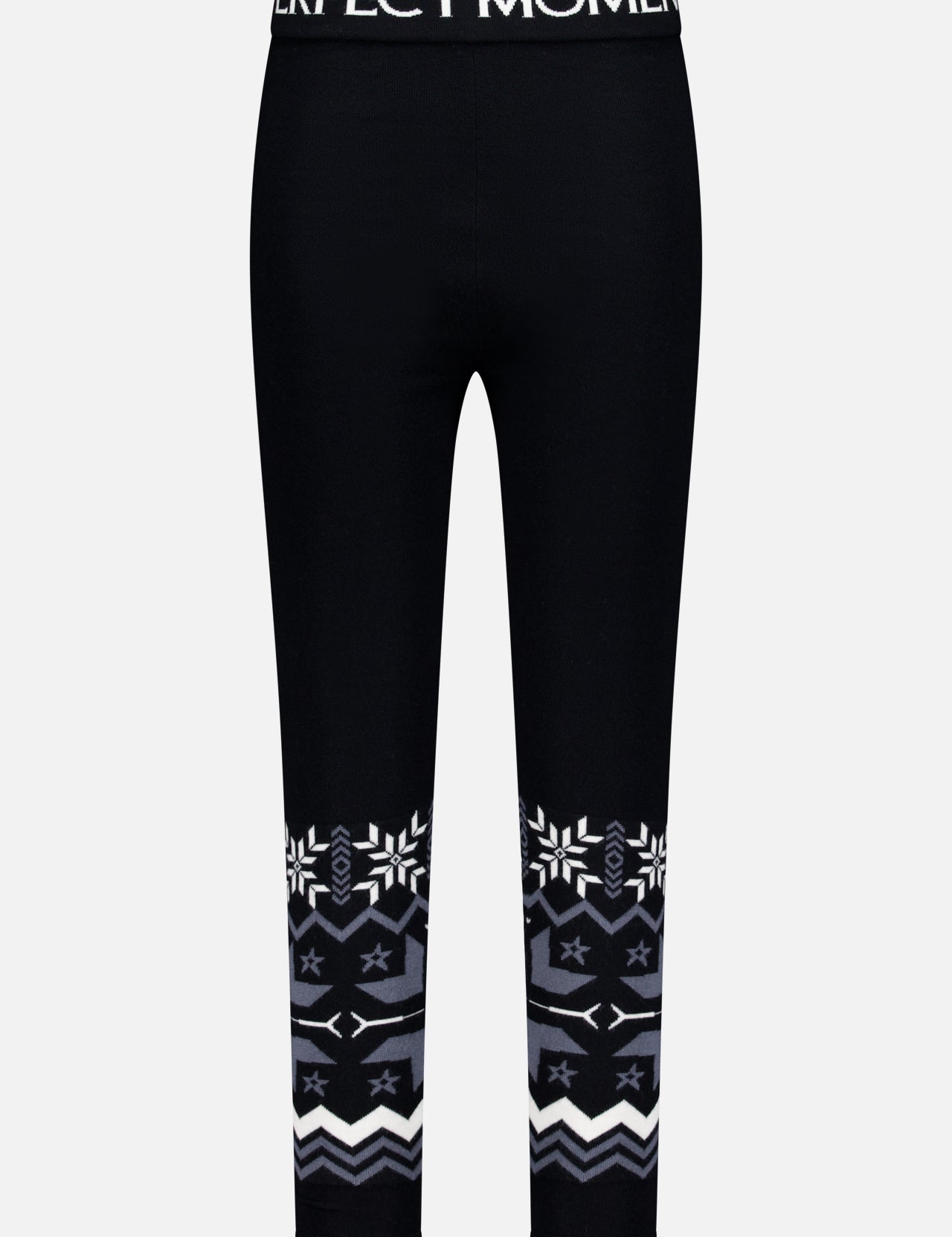 The Nordic Merino Wool Legging by PERFECT MOMENT features a black, cropped fit with white logo on the waistband and a bold snowflake intarsia design in white and gray at the lower legs—perfect for stylish après-ski wear.