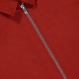 Close-up of the PESCAROLO Avi Wool Jersey Zip Unlined Jacket, a red piece with Italian-inspired smooth fabric and a silver zipper running from chest to collar, partially unzipped for a stylish touch.