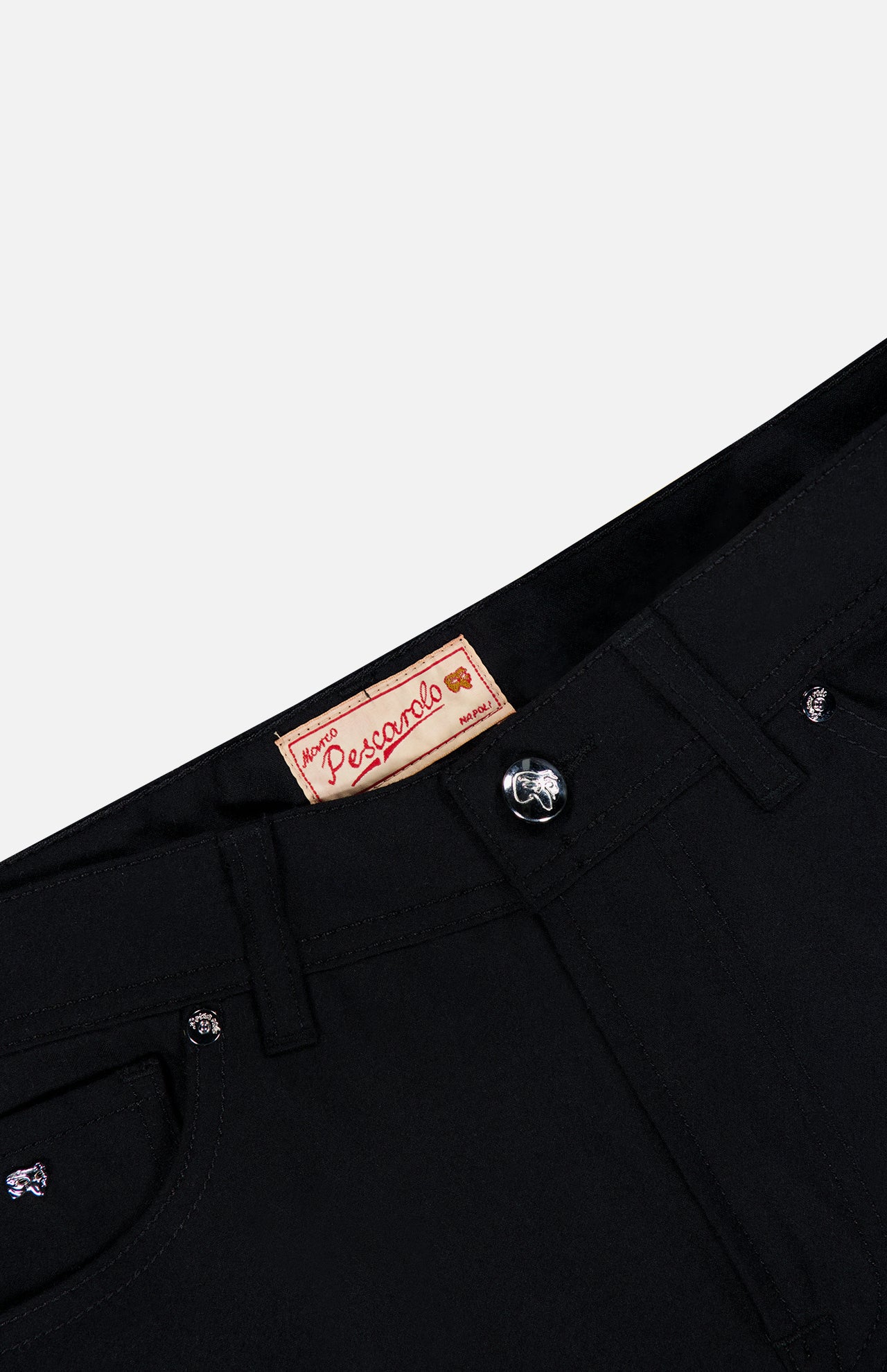 Close-up of the waistband and top front of black Nerano M Cashmere Pants featuring a silver button, belt loops, and a tan label with “PESCAROLO” in red text. Expertly crafted in Italy, these pants offer a classic 5-pocket design for both style and functionality.