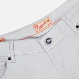 Close-up of the Nerano M Cotton Silk 5 Pockets Pant by PESCAROLO in light beige, showing the button with anchor design and a PESCAROLO label sewn inside the waistband.