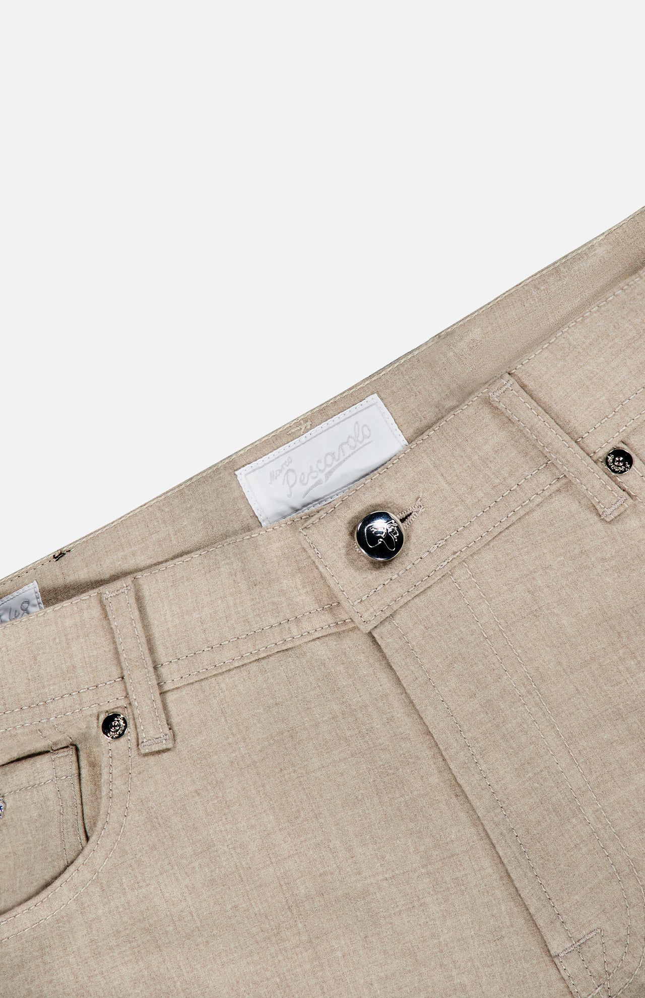 Close-up of the Nerano M Flannel Pants by PESCAROLO in beige cashmere, highlighting the waistband, dark button, belt loops, pockets, and a white fabric label with faint text. This stylish 5-pocket design provides both elegance and practicality.