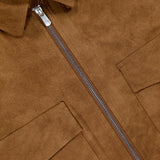 Close-up of the Urus Faux Suede Zip Jacket by PESCAROLO, showing a brown faux suede finish, silver zipper, two flap chest pockets, and a classic collar—reflecting Italian craftsmanship and premium material quality.