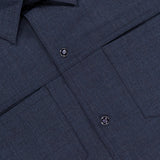 Close-up of the Zeus Wool Snap Front Overshirt by PESCAROLO in dark blue, featuring a smooth virgin wool-blend, collar, two chest flap pockets, black snap buttons, and visible stitching—perfect for men’s travel wear.