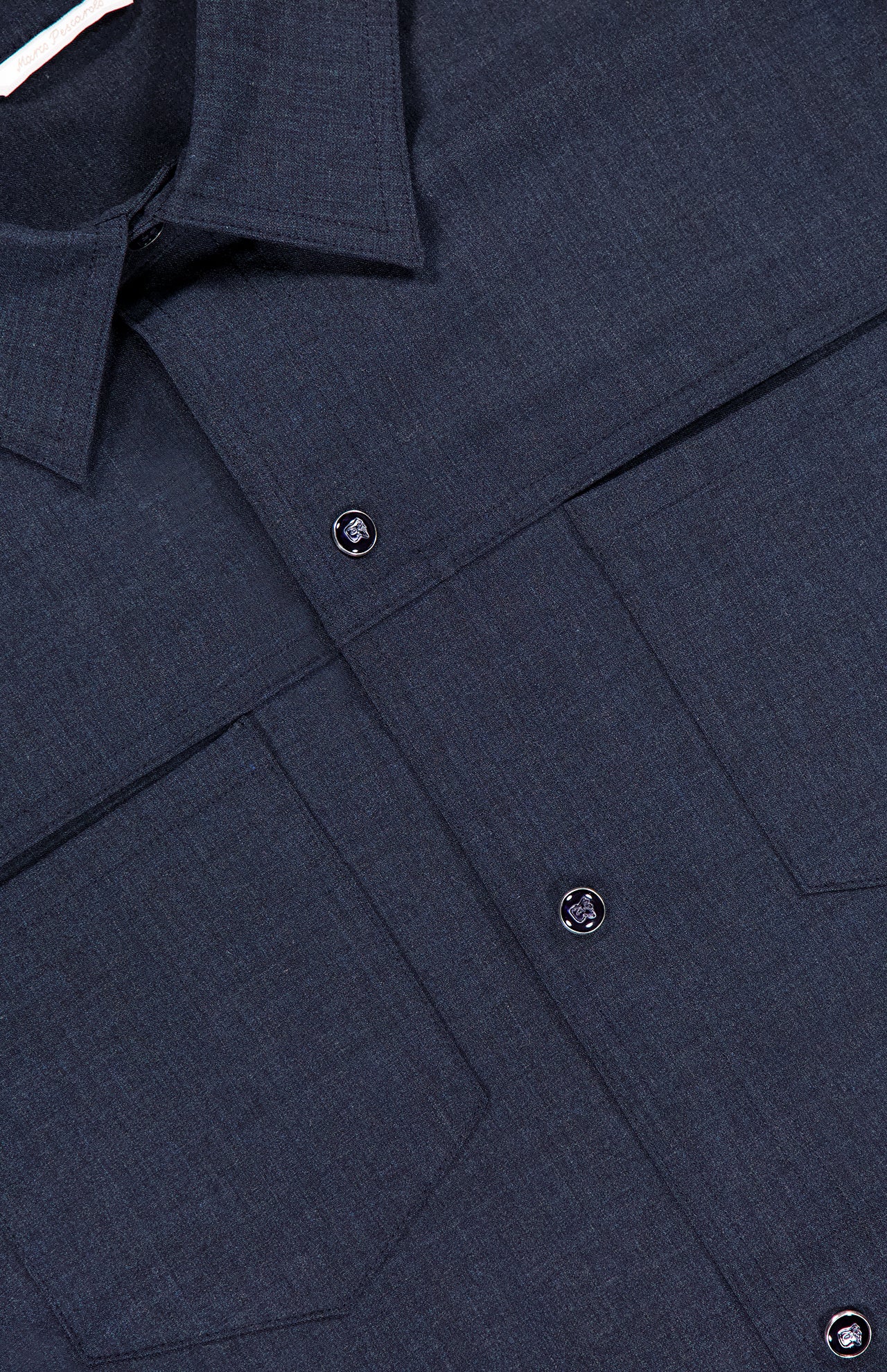 Close-up of the Zeus Wool Snap Front Overshirt by PESCAROLO in dark blue, featuring a smooth virgin wool-blend, collar, two chest flap pockets, black snap buttons, and visible stitching—perfect for men’s travel wear.
