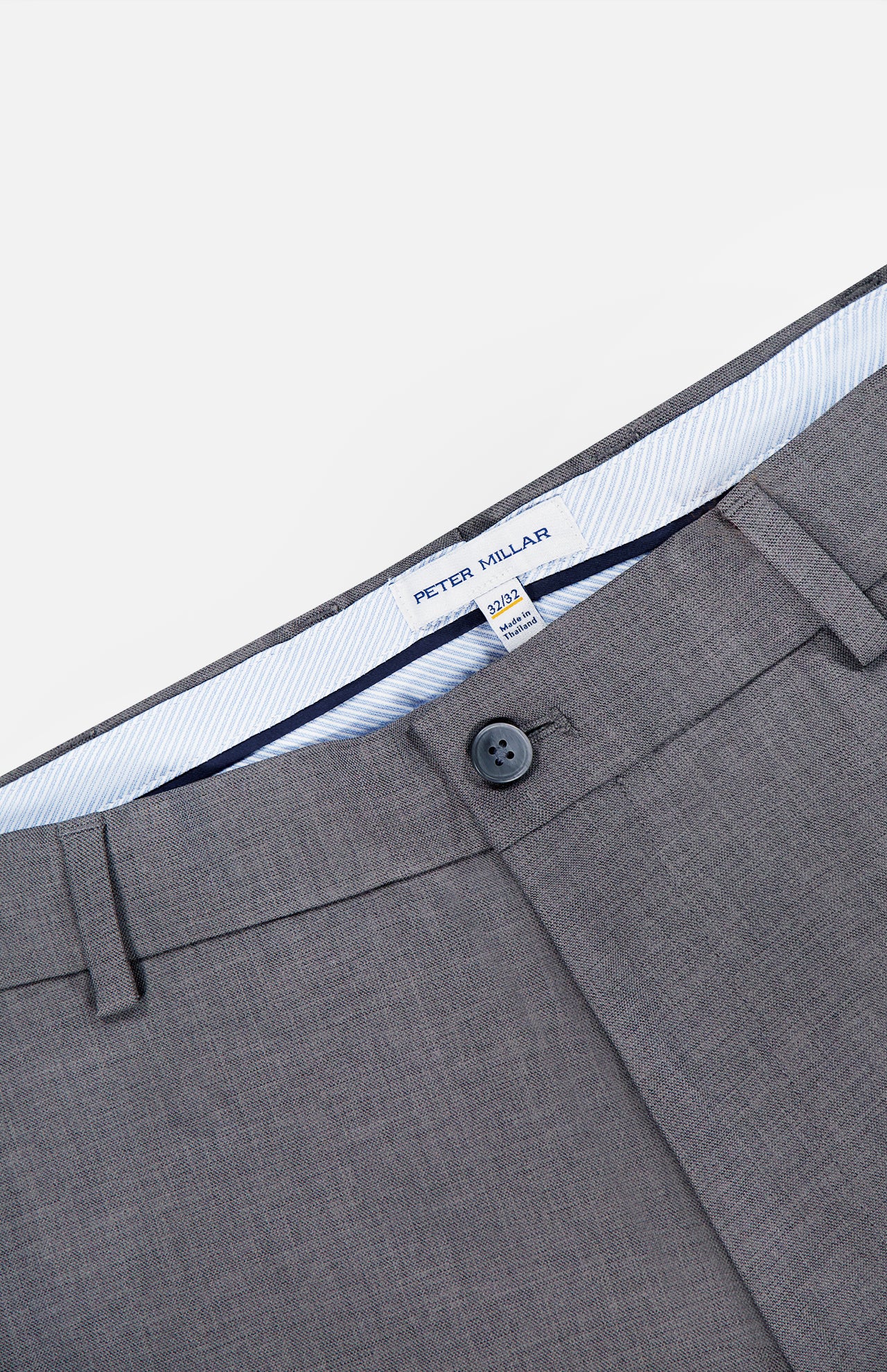 The Charlotte Performance Trouser Pant by PETER MILLAR features a gray stretch mélange fabric with a smooth, slightly textured finish for added comfort. Details include a single black button, belt loops, and a visible inner waistband label that reads PETER MILLAR.