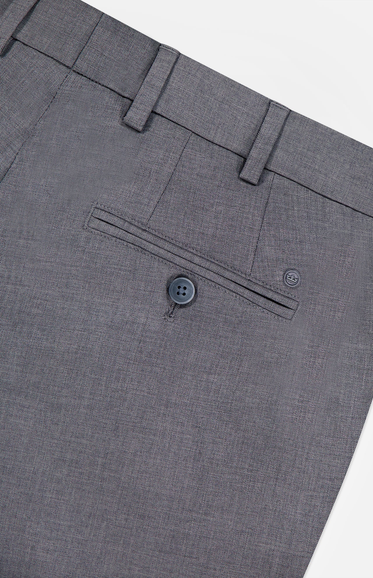 Close-up of the back pocket area of the PETER MILLAR Charlotte Performance Trouser Pant in gray stretch mélange, featuring a single buttoned welt pocket, belt loops, and subtly textured fabric.