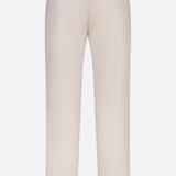 Back view of the PETER MILLAR Charlotte Performance Trouser Pant in light beige stretch mélange fabric, with belt loops, two buttoned welt pockets, and a straight leg silhouette, shown against a plain white background.
