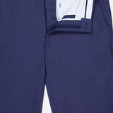 A pair of PETER MILLAR Charlotte Performance Trouser Pants in navy blue stretch mélange, shown with the front fly unzipped and waistband open to reveal the striped inner lining and button closure.